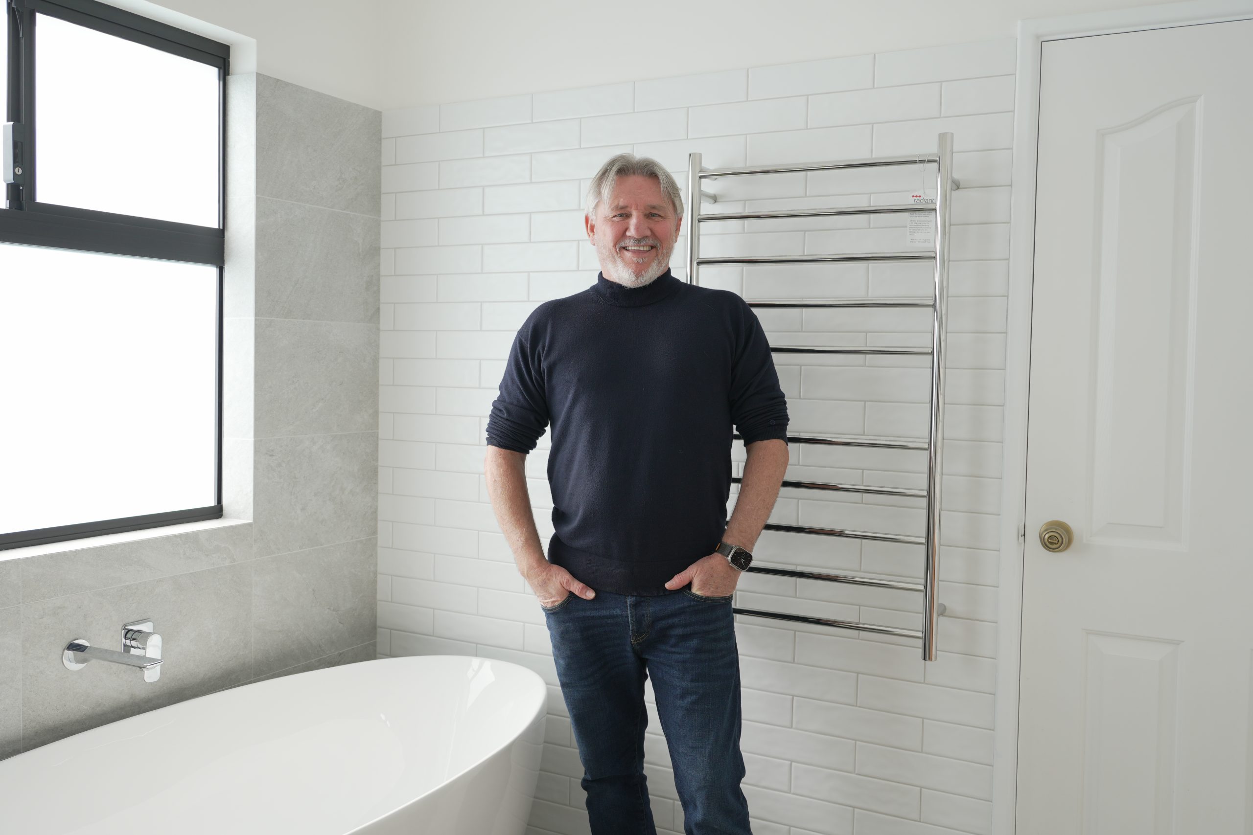 Derek from Immaculate Bathrooms Perth standing beside a luxury renovated bathroom