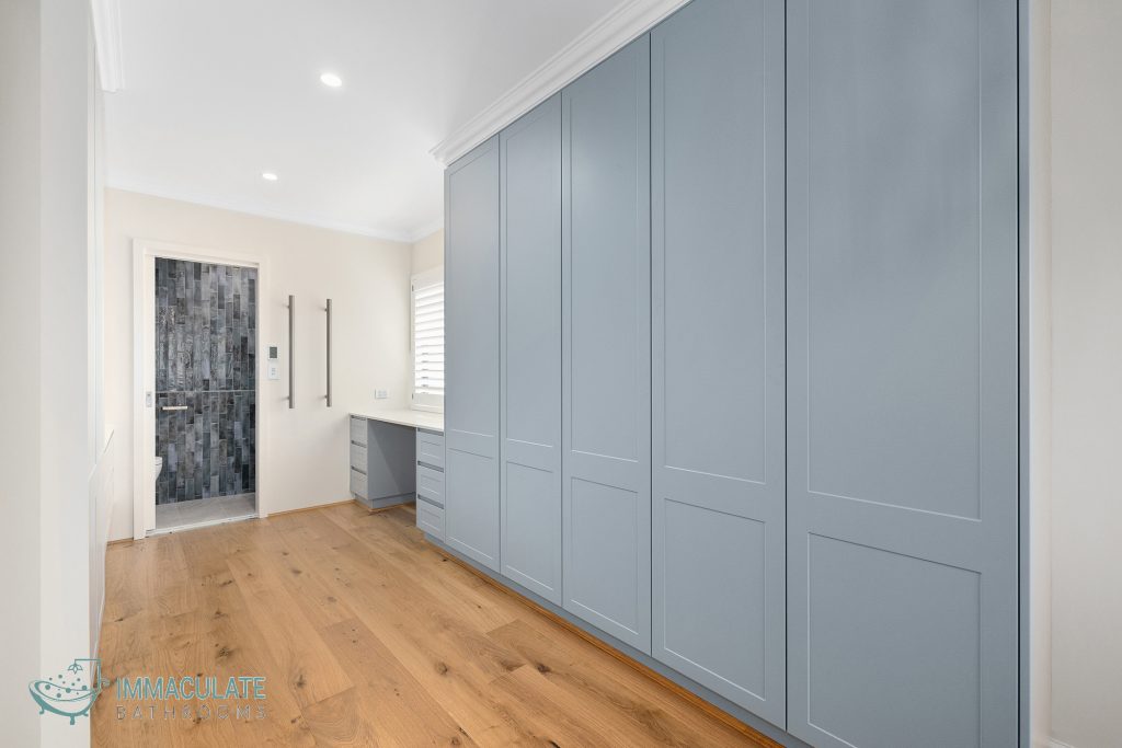 Modern Perth home renovation with custom blue cabinetry, timber flooring and ensuite bathroom upgrade by Immaculate Bathrooms Perth